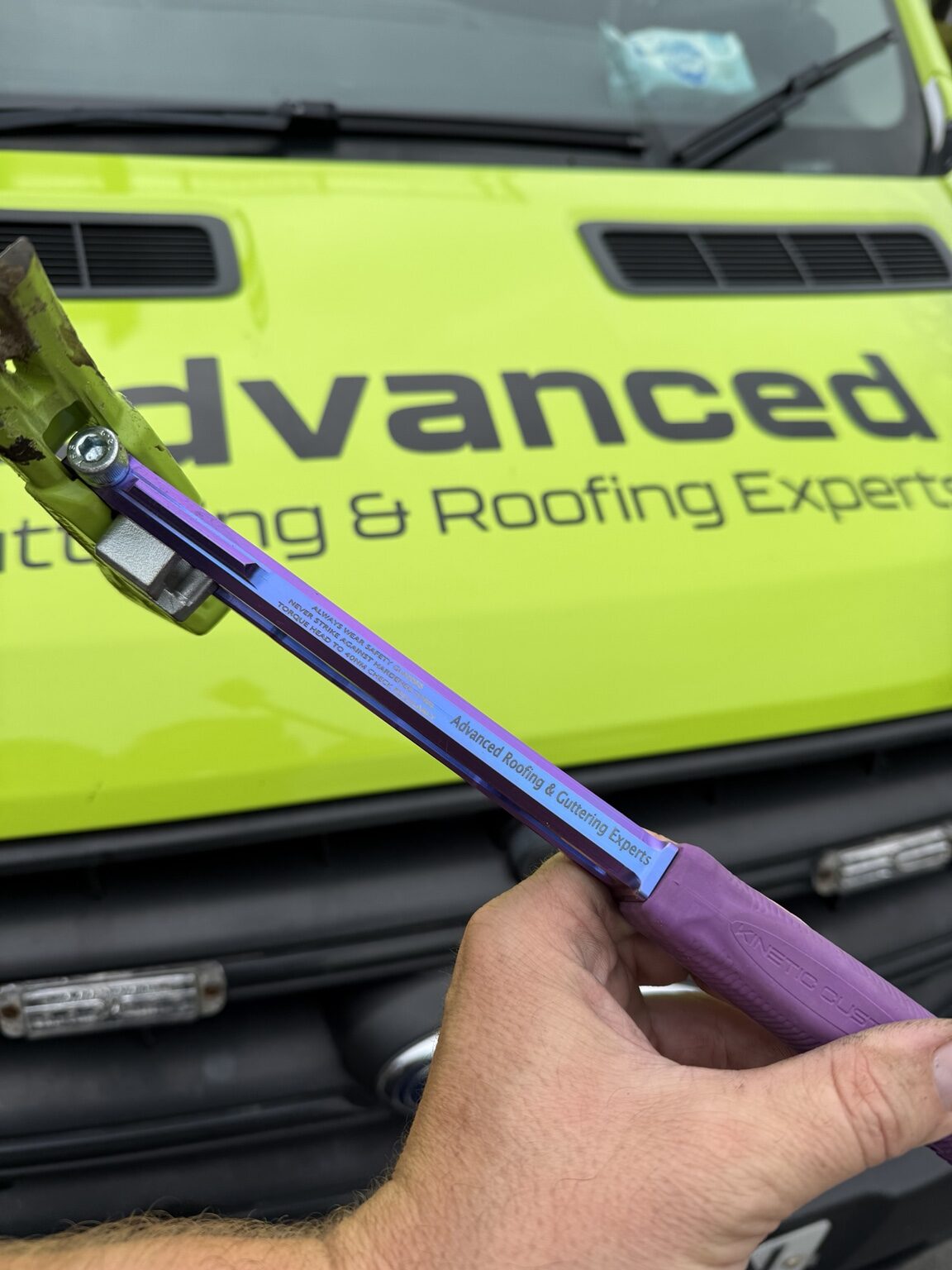Professional roofing tool in front of the Advanced Roofing and Guttering van