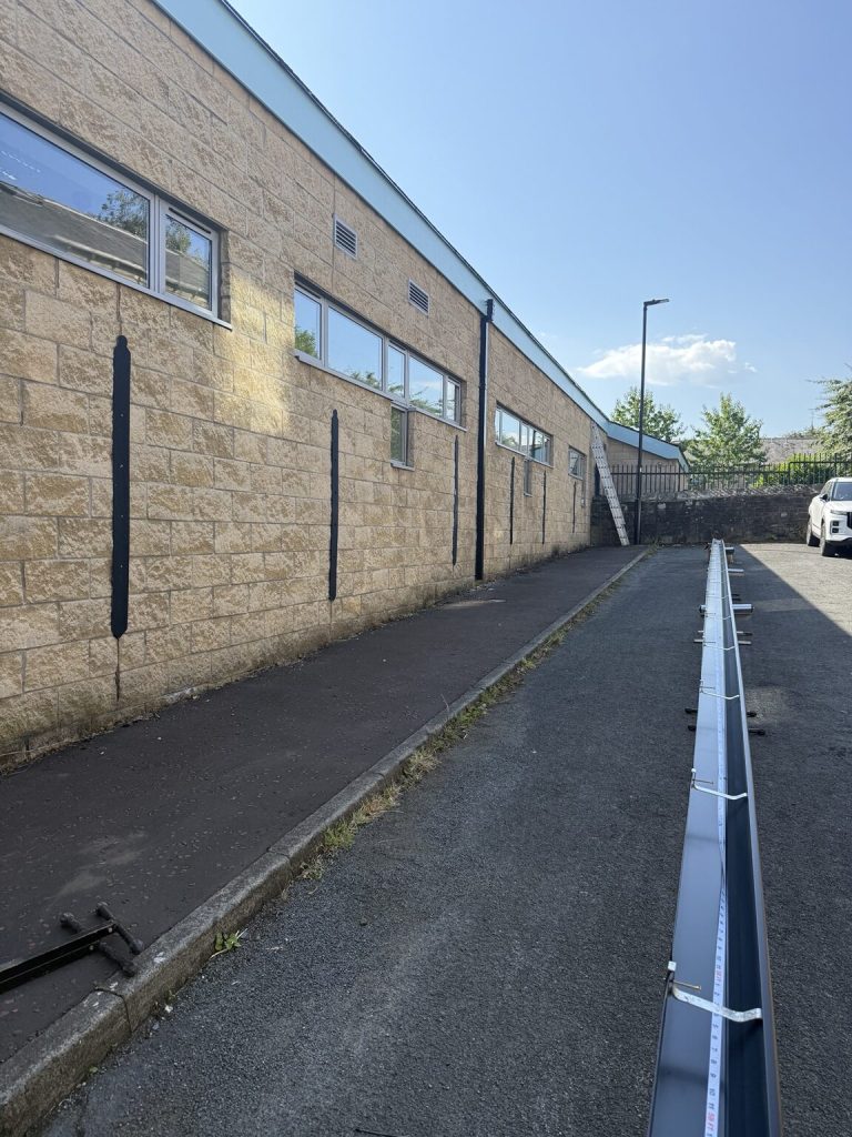 Long run of newly formed seamless aluminium guttering ready for installation